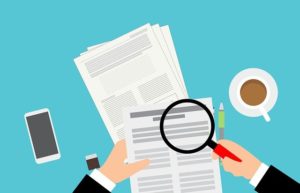 Graphic of person analysing papers